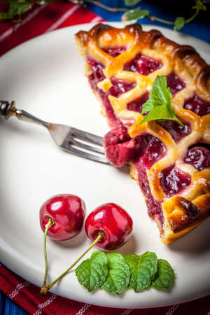 Homemade cherry pie on blue background. Selective focus.の写真素材