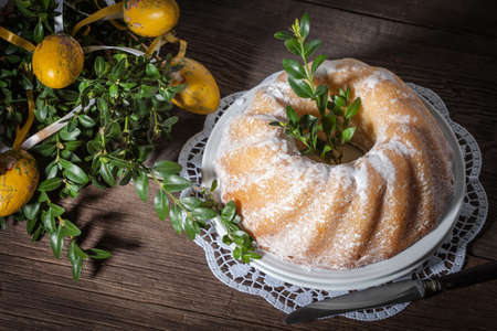 Traditional easter cake on a wooden table. Dark light.の写真素材