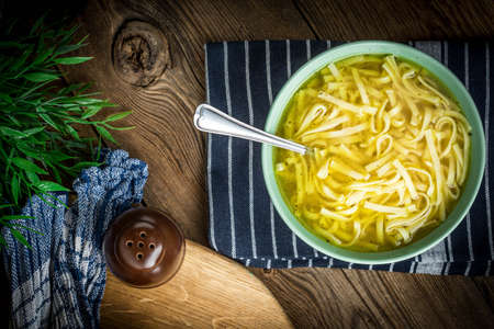 Broth - chicken soup with noodles in a bowl.
