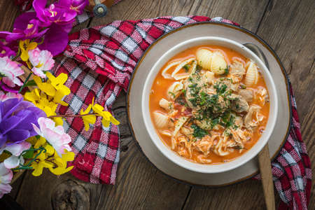 Fresh tomato soup with conchigliette in a white bowl. Top view.の写真素材