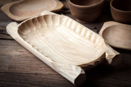 Old wooden utensils on a brown table. Selective focus.