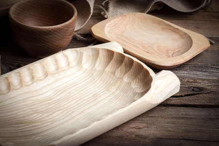 Old wooden utensils on a brown table. Selective focus.