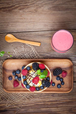 Tasty ice cream dessert with fruit in a waffle bowl. Top view.の写真素材