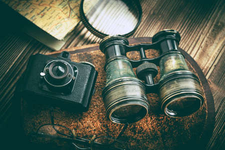 Magnifying glass and binoculars on the old map. Vintage style. Selective focus.の写真素材