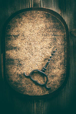 An old corkscrew on a cork background. Vintage style.の写真素材