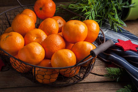 Basket of tangerines on a wooden table. Selective focus.の写真素材