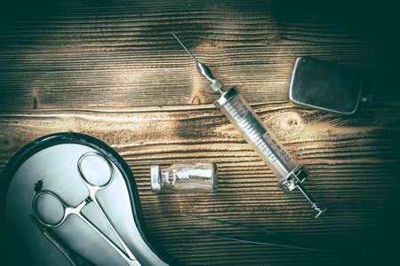 Old medicine equipment on wooden background. Vintage style.の写真素材