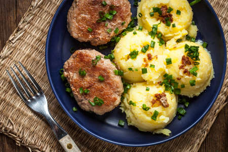 Meatballs served with boiled potatoes on a plate.の写真素材