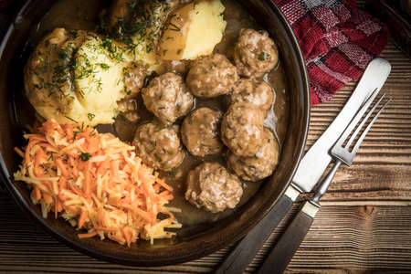 Swedish meatballs in dill sauce served with mashed potatoes and carrot salad.の写真素材