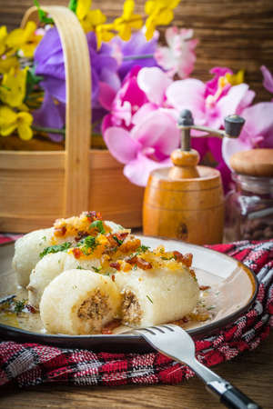 Potato dumplings stuffed with minced meat on wooden table.の写真素材