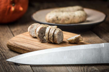 Sliced tasty white sausage. Dark light. Small depth of field.の写真素材