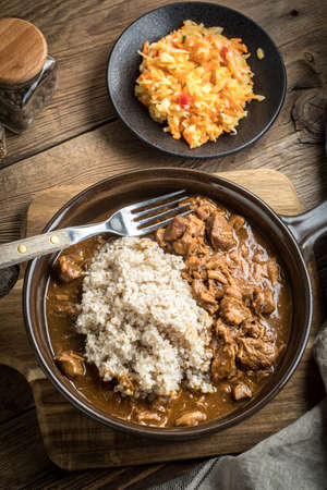 Barley groats with stewed meat served on a pan.の写真素材