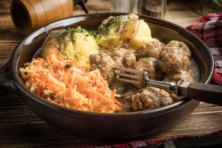 Swedish meatballs in dill sauce served with mashed potatoes and carrot salad.