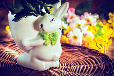 Flowers in a pot in the shape of Easter bunny. Filtered style.の写真素材