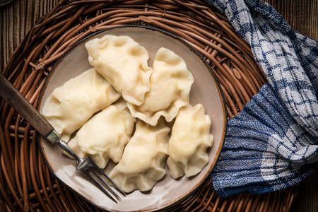 Homemade dumplings with cheese on a plate. Top view.の写真素材