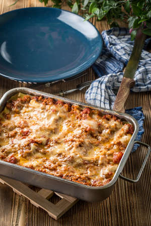 Homemade lasagne bolognese in metal baking form.の写真素材