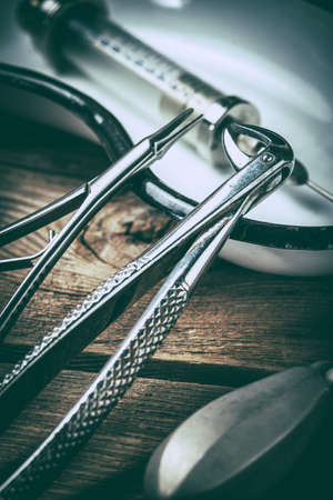 Retro medical tools on a wooden table. Selective focus. Filtered style.の写真素材