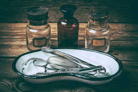 Retro medical tools on a wooden table. Selective focus. Filtered style.の写真素材