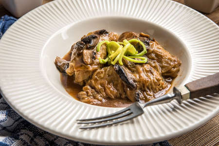 Stuffed cabbage leaves with minced meat and rice in mushroom sauce.の写真素材