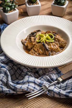Stuffed cabbage leaves with minced meat and rice in mushroom sauce.の写真素材