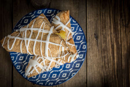 French pastry with pudding and icing. Small depth of field. Top view.