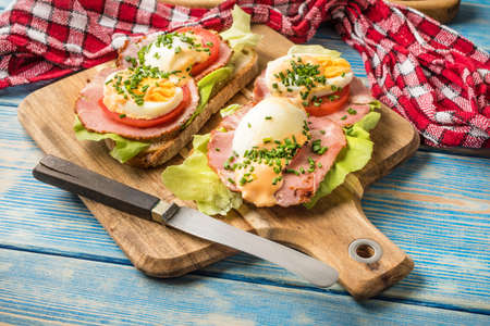 Sandwich with tomatoes, eggs and lettuce for breakfast.の写真素材