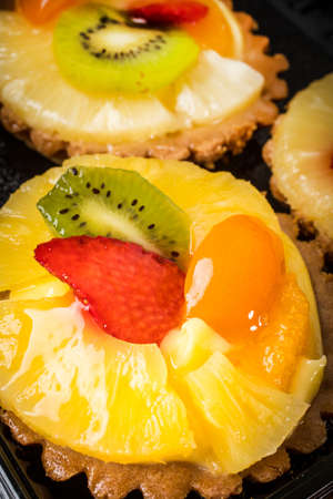 Fresh  mixed fruit tart with strawberries, pineapple and kiwi, . Selective focus.の写真素材