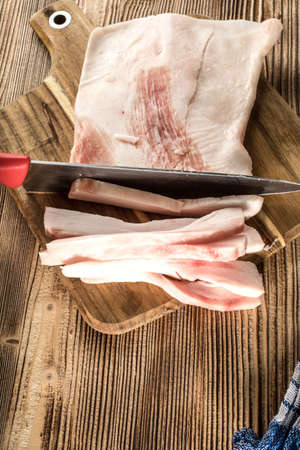 Sliced fresh lard on a chopping board.の写真素材