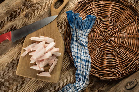 Sliced fresh lard on a chopping board.