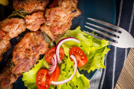 Shish kebabs - grilled meat, fried potatoes and vegetables.の写真素材