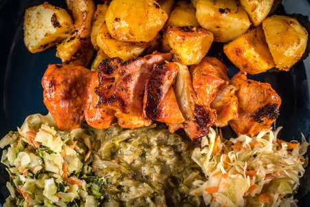 Shish kebab with roasted potatoes and three kinds of salads.