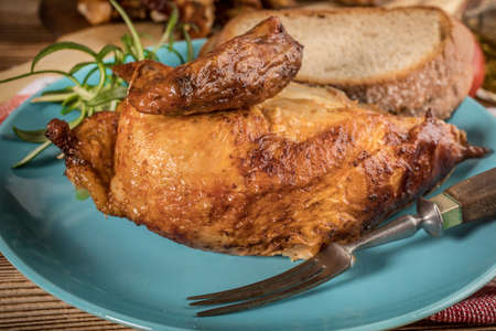 Pieces of roast chicken on a blue plate.