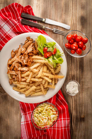 Greek gyros with fries and salad on plate. Top view.の写真素材