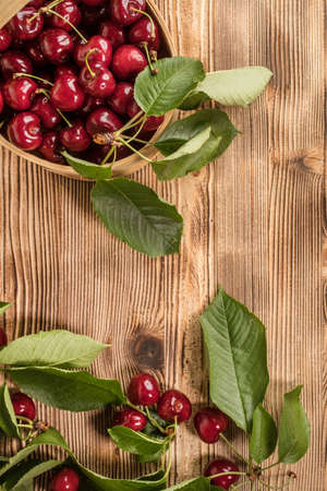 Sweet cherries in a wooden basket. Selective focus. Top view.の写真素材