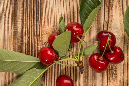 Fresh sweet cherries on a wooden background. Top view and copy space.の写真素材