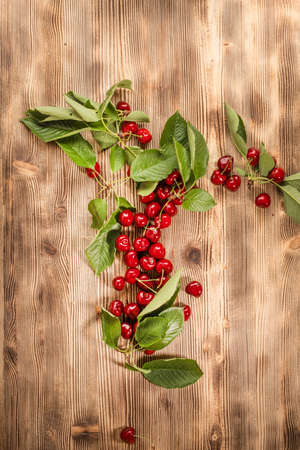 Fresh sweet cherries on a wooden background. Top view and copy space.の写真素材