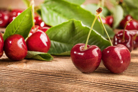 Fresh sweet cherries on a wooden background.の写真素材