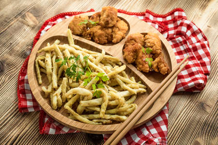 Crispy chicken nuggets with yellow bean on bamboo plate.の写真素材