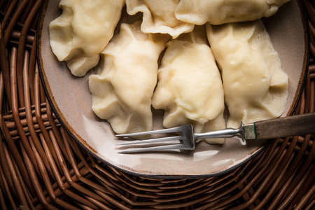 Homemade dumplings with cheese on a plate. Top view.の写真素材