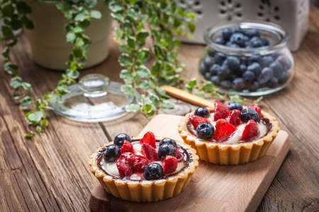 Fresh homemade fruit tart with strawberries and blueberries. Selective focus.の写真素材