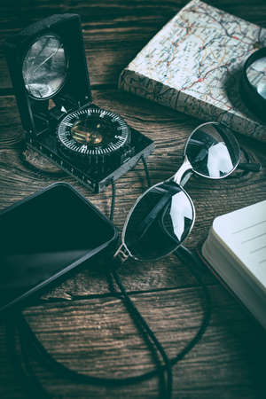 Gadgets needed for tourists on a wooden table.の写真素材