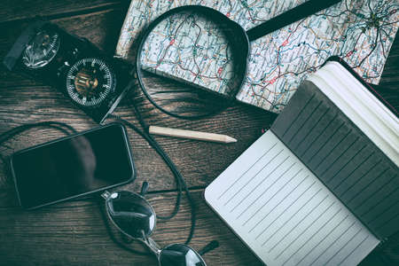 Gadgets needed for tourists on a wooden table.