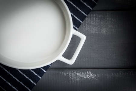 Empty dish for baking on a dark countertop. Dark light.