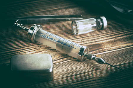 Old medicine equipment on wooden background. Vintage style.の写真素材