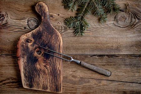 Empty wooden cutting board on kitchen table.