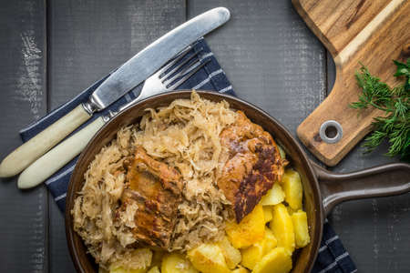 Fried ribs in sauerkraut served with roasted potatoes. Top view.の写真素材
