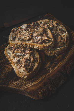 Slices of multigrain bread with sprats.