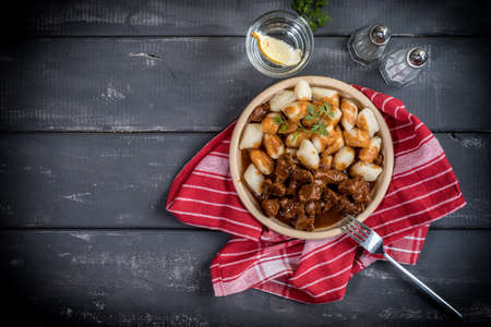 Chunky beef stew with savory sauce beside potato dumplings. Top view.の写真素材
