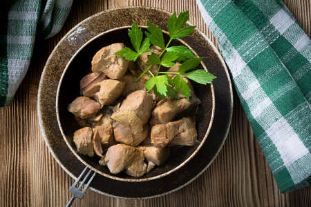 Stewed turkey meat in a brown bowl.の写真素材