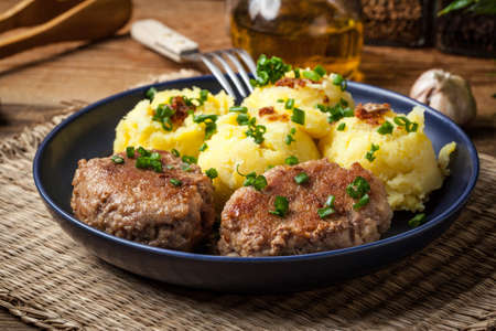 Meatballs served with boiled potatoes on a plate.の写真素材